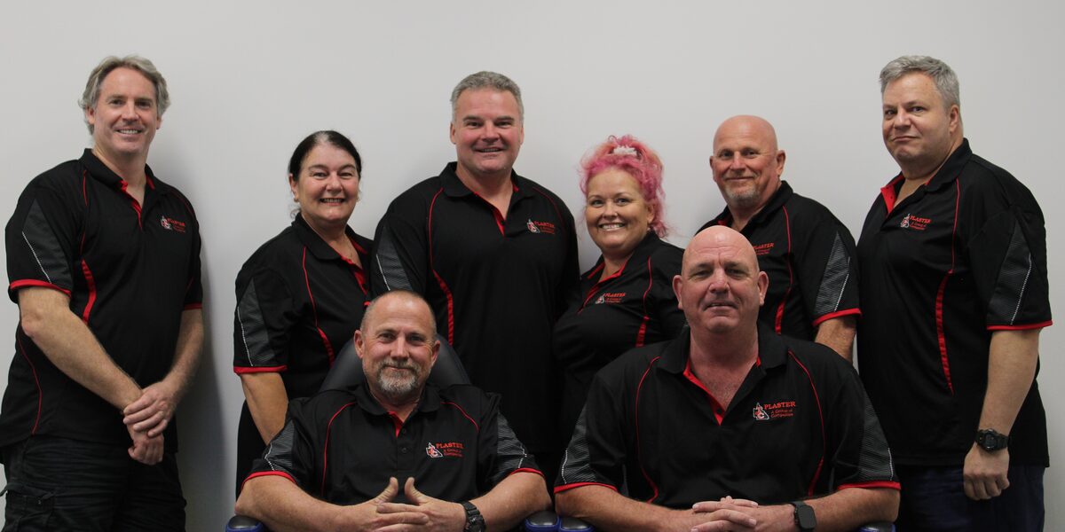The T&C Plaster team together in their black and red company polos
