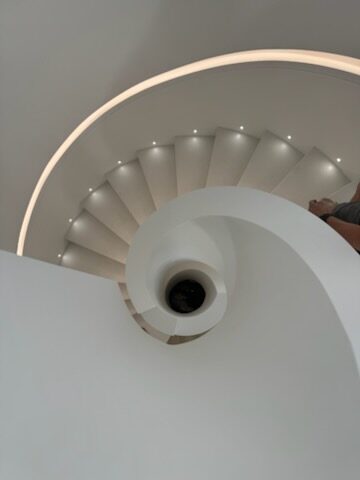 Finished glossy white spiral staircase with feature lighting