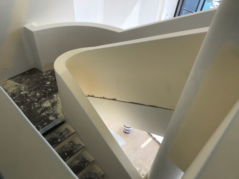 A completed T&C Plaster plastering project — curved staircase void