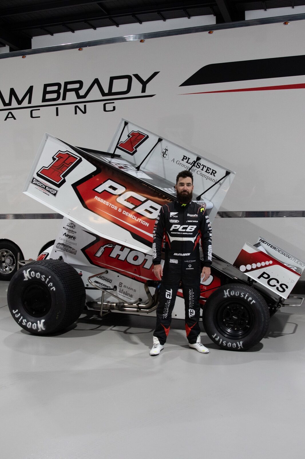 James McFadden standing in front of the Team Brady Racing No. 1 sprintcar, featuring T&C Plaster sponsorship branding